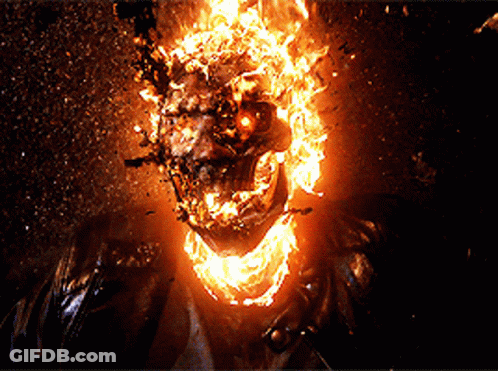A Close Up Of A Ghost Rider With Flames Coming Out Of His Face GIF