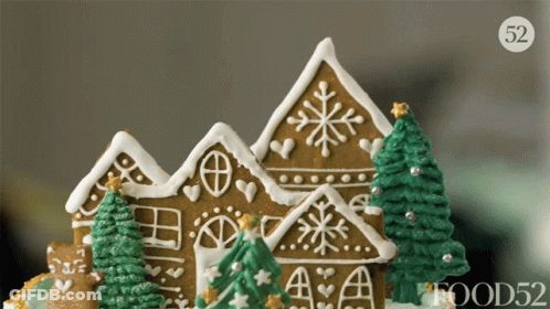 A Close Up Of A Gingerbread House With Trees And A Food52 Logo GIF
