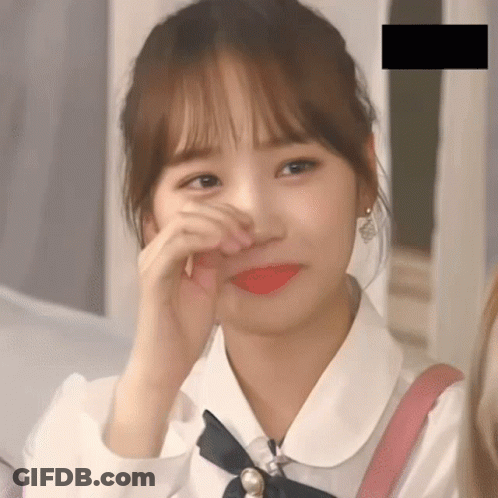 A Close Up Of A Girl Covering Her Face With Her Hands GIF