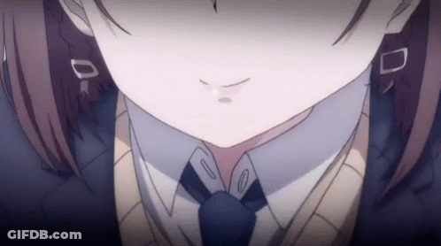 A Close Up Of A Girl 'S Face Wearing A Tie And Sweater . GIF