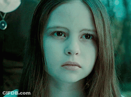 A Close Up Of A Girl 'S Face With A Blue Background GIF