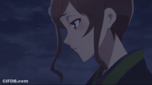 A Close Up Of A Girl 'S Face With A Dark Background GIF