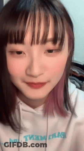 A Close Up Of A Girl 'S Face With A Hoodie That Says " Team " GIF