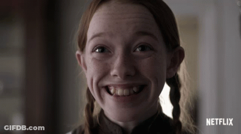A Close Up Of A Girl 'S Face With A Netflix Logo Behind Her GIF