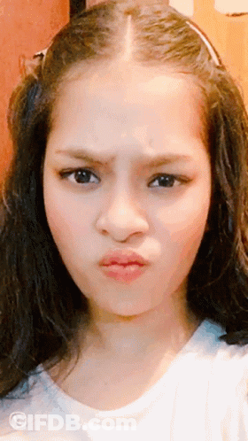 A Close Up Of A Girl 'S Face With A Phone Number On The Bottom Left GIF