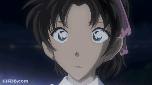 A Close Up Of A Girl 'S Face With A Pink Ribbon In Her Hair GIF