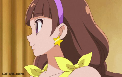 A Close Up Of A Girl 'S Face With A Purple Headband And Yellow Earrings GIF