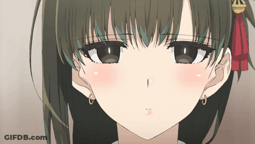 A Close Up Of A Girl 'S Face With A Red Bow On Her Head GIF