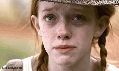 A Close Up Of A Girl 'S Face With A Tear Running Down Her Cheek . GIF