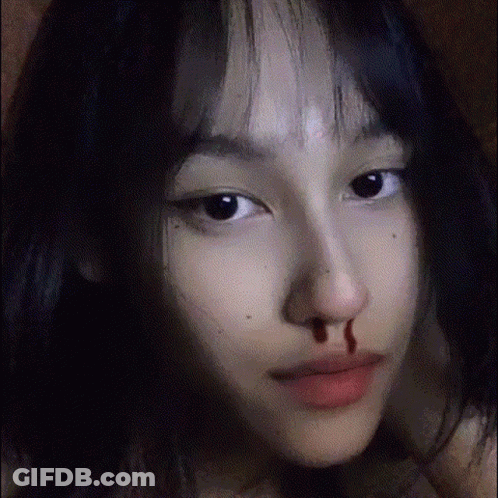 A Close Up Of A Girl 'S Face With Blood On Her Nose . GIF