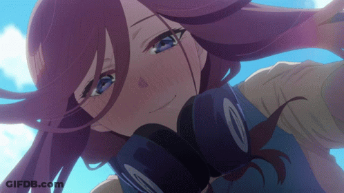 A Close Up Of A Girl 'S Face With Headphones Around Her Neck GIF