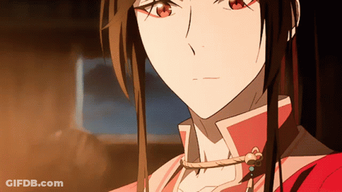 A Close Up Of A Girl 'S Face With Long Hair And Red Eyes GIF