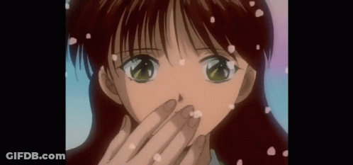 A Close Up Of A Girl 'S Face With Petals Falling On It GIF