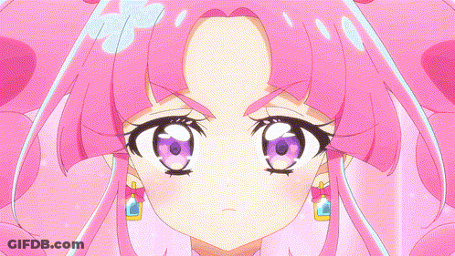A Close Up Of A Girl 'S Face With Pink Hair And Purple Eyes GIF