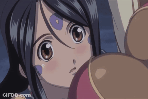 A Close Up Of A Girl 'S Face With Purple Circles On Her Forehead GIF