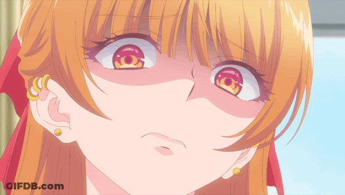 A Close Up Of A Girl 'S Face With Red Eyes And Gold Earrings GIF