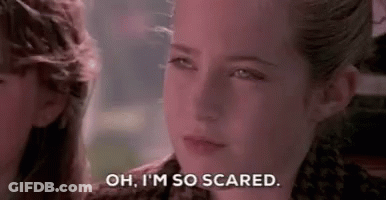 A Close Up Of A Girl 'S Face With The Words `` Oh , I 'M So Scared '' Written On It . GIF