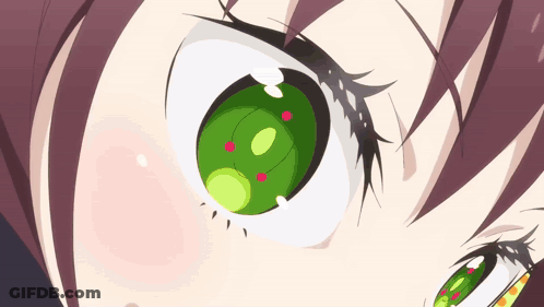 A Close Up Of A Girl 'S Green Eye With Red Dots GIF