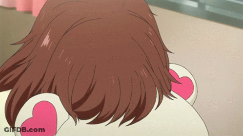 A Close Up Of A Girl 'S Hair With A Pink Heart On Her Ear GIF