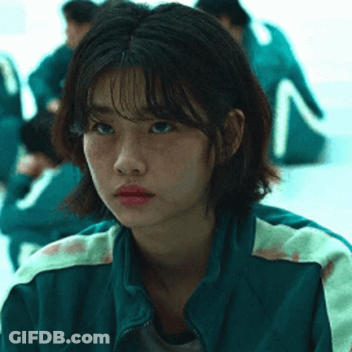 A Close Up Of A Girl Wearing A Green Jacket . GIF