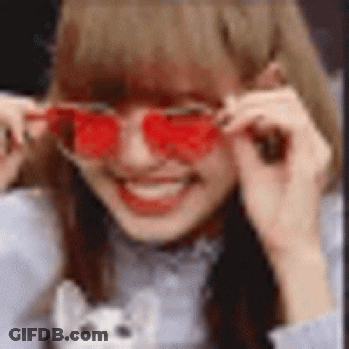 A Close Up Of A Girl Wearing Red Sunglasses . GIF