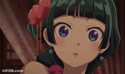 A Close Up Of A Girl With Green Hair And Purple Eyes GIF