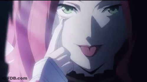 A Close Up Of A Girl With Pink Hair Sticking Her Tongue Out . GIF