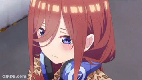 A Close Up Of A Girl With Red Hair And Blue Eyes Wearing Headphones . GIF