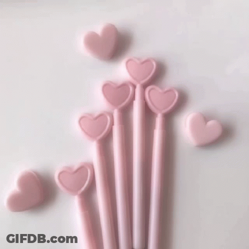 A Close Up Of A Glass Of Pink Liquid With Heart Shaped Ice Cubes GIF