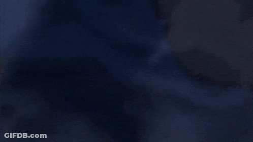 A Close Up Of A Glowing Object In The Dark With A Red Light Coming Out Of It . GIF