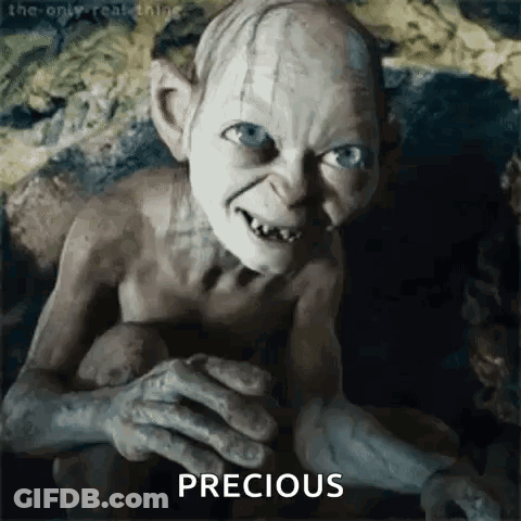 A Close Up Of A Gollum From The Lord Of The Rings Holding A Potato . GIF