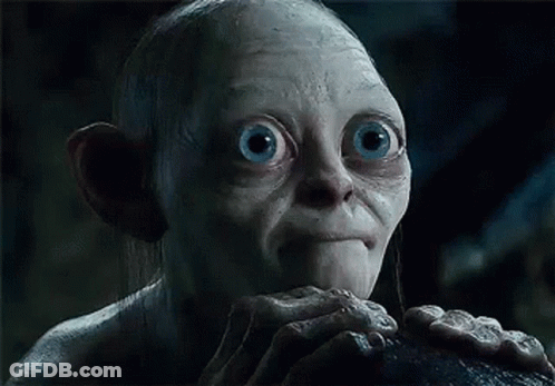 A Close Up Of A Gollum From The Lord Of The Rings With Big Blue Eyes And A Beard . GIF