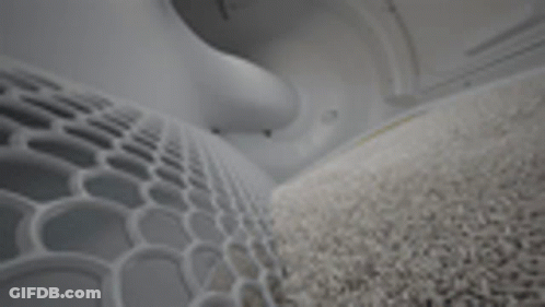 A Close Up Of A Gray Carpet In A Room With A Geometric Pattern . GIF