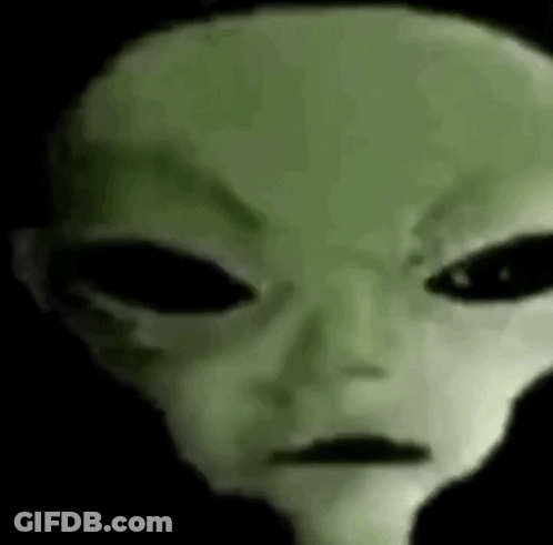 A Close Up Of A Green Alien 'S Face With Big Black Eyes . GIF