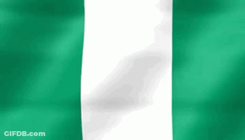 A Close Up Of A Green And White Flag Waving In The Wind . GIF