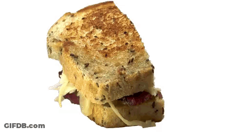 A Close Up Of A Grilled Cheese Sandwich With Meat And Cheese GIF