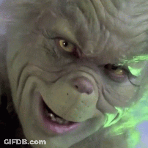 A Close Up Of A Grinch 'S Face With A Smile On His Face GIF