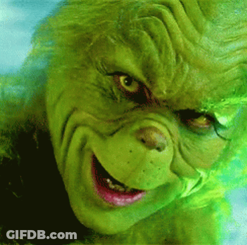 A Close Up Of A Grinch 'S Face With A Smile On It GIF
