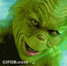 A Close Up Of A Grinch 'S Face With A Smile . GIF