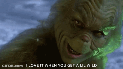 A Close Up Of A Grinch With The Words I Love It When You Get A Lil Wild On The Bottom GIF