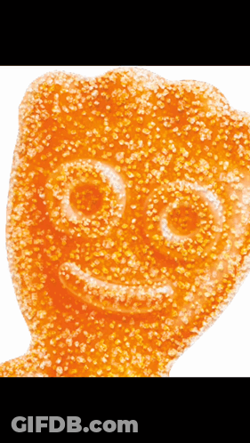 A Close Up Of A Gummy Bear With A Smile On Its Face GIF