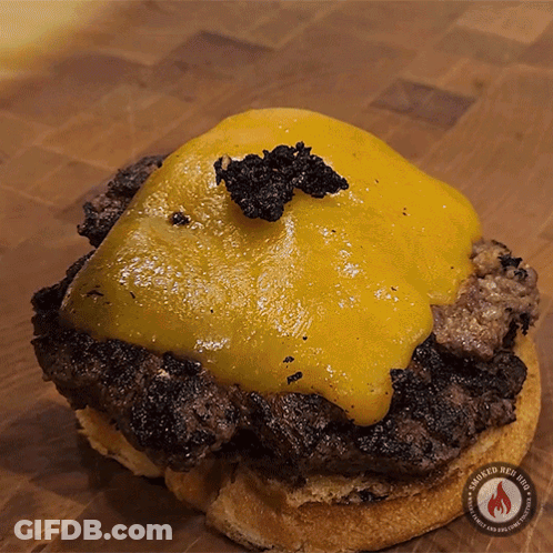 A Close Up Of A Hamburger On A Bun With Smoked Red Hot Written On The Bottom GIF
