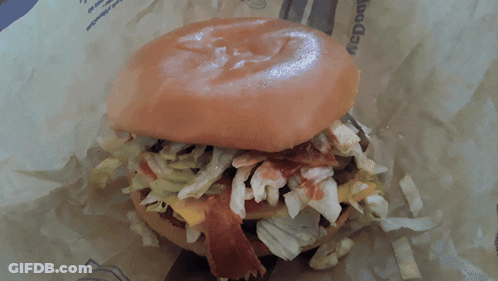 A Close Up Of A Hamburger With Lettuce And Bacon On It GIF