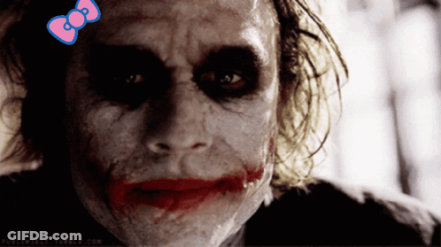 A Close Up Of A Joker With A Pink Bow On His Head GIF