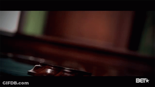 A Close Up Of A Judge 'S Gavel With A Bet Logo Below It GIF