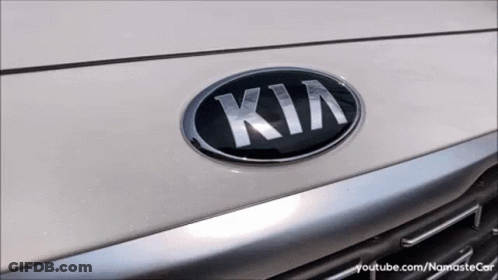 A Close Up Of A Kia Emblem On The Front Of A Car GIF