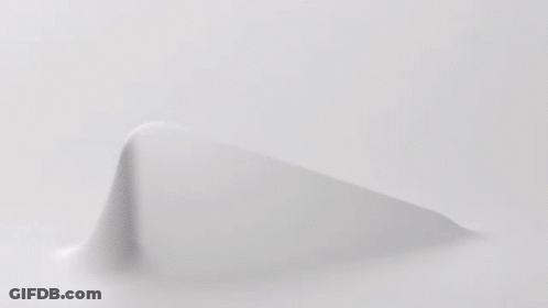 A Close Up Of A Knitted Fabric With A Geometric Pattern On It . GIF
