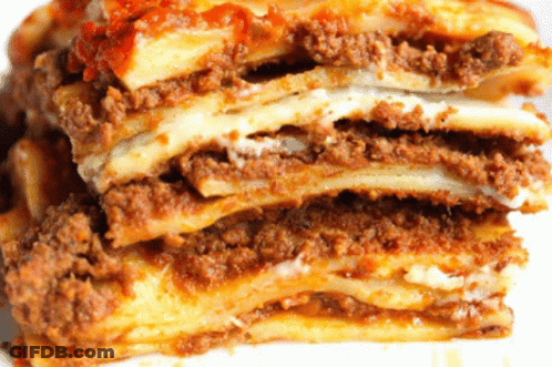 A Close Up Of A Lasagna With Meat And Cheese GIF