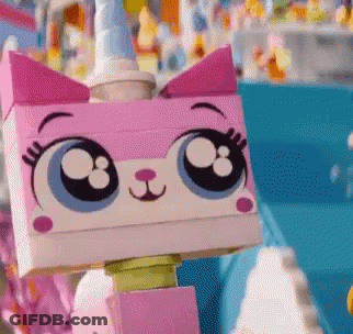 A Close Up Of A Lego Cat With Big Eyes And A Unicorn Horn GIF