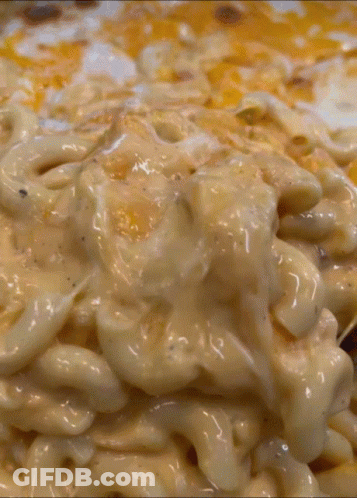 A Close Up Of A Macaroni And Cheese Casserole Dish GIF